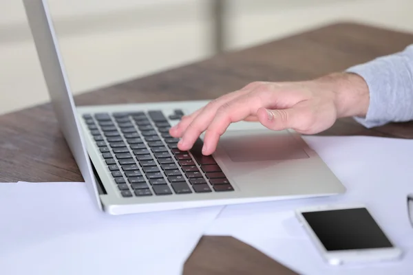 Man working with laptop in office