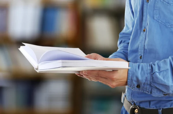 Male hands holding open book