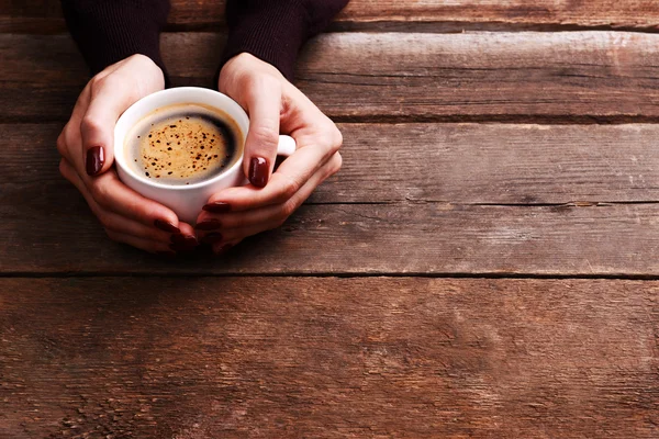 Female hands holding cup