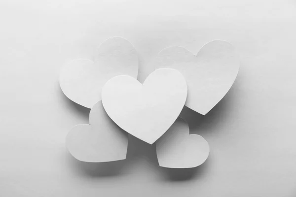 White hearts on white paper background