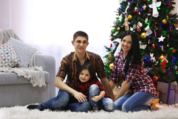 Happy family in the decorated Christmas room