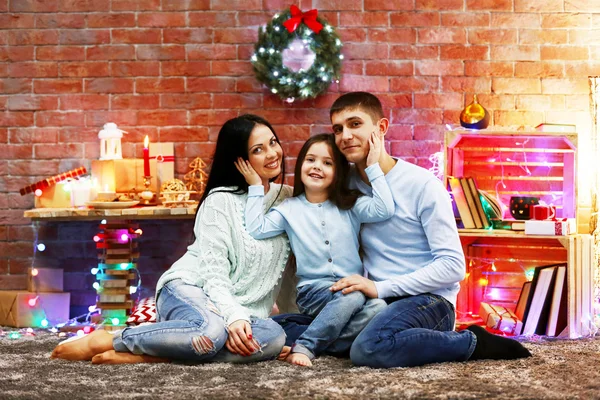 Happy family in the decorated Christmas room