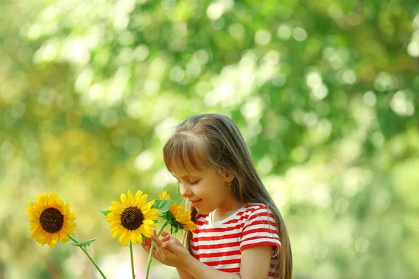 Little girl with sunflowers