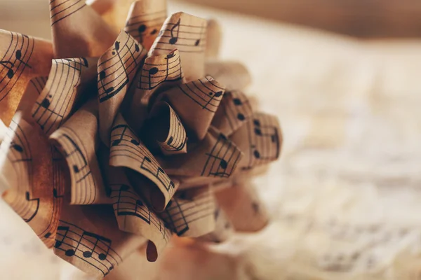 Beautiful paper-made rose on musical notes