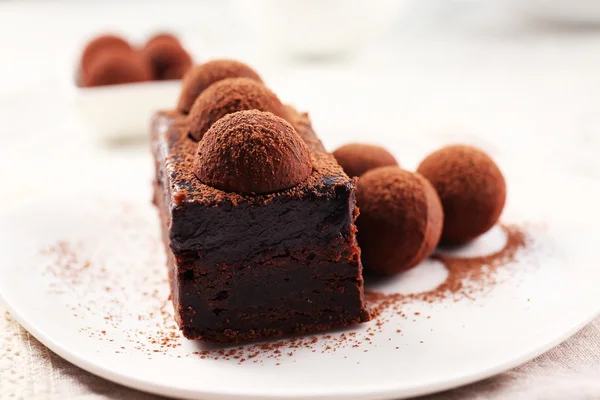 Slice of chocolate cake with a truffle