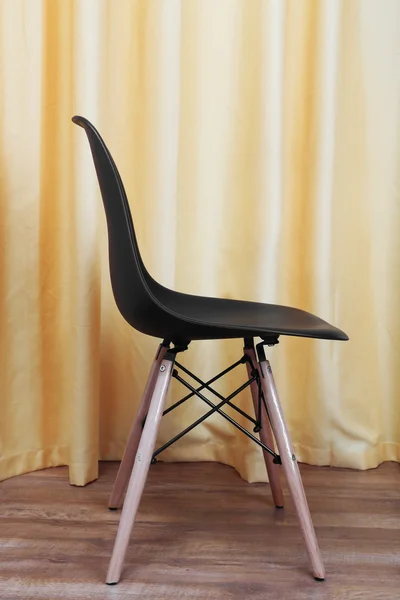 Black chair on a curtain background