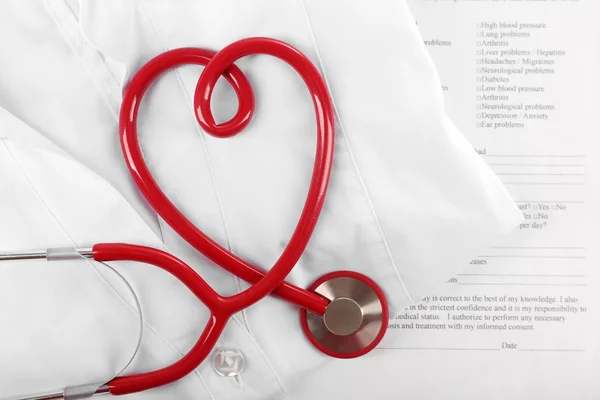 Red stethoscope, medical record and uniform