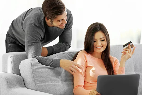 Happy couple using credit card