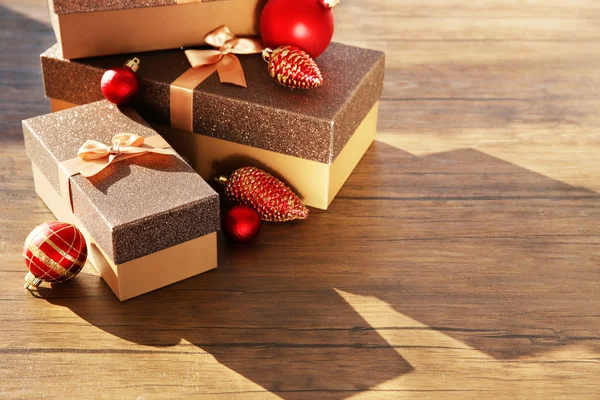 Box with Christmas toys on wooden background