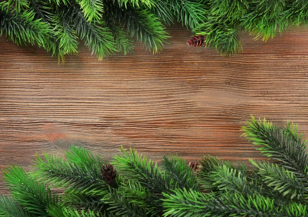 Christmas fir tree branches on wooden table