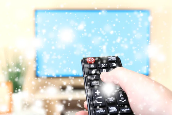 Watching TV and using remote controller  over snow effect