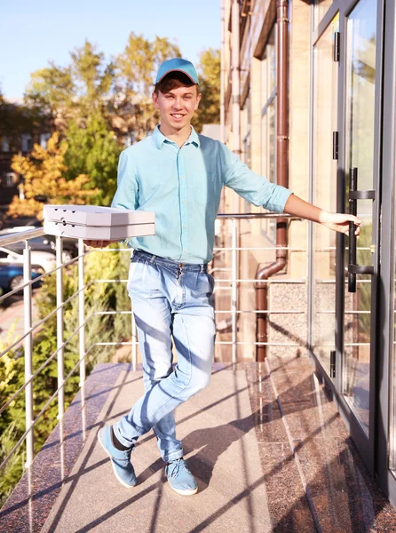 Delivery boy with pizza boxes