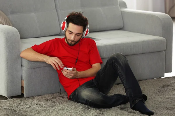 Handsome man listens music with headphones