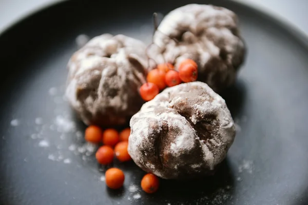 Chocolate balls with ash berry on plate closeup