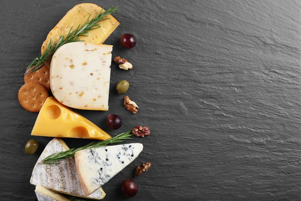 Composition of fresh cheese, fruits and vegetables on black background, copy space