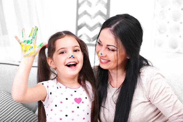 Mother and daughter playing in the room