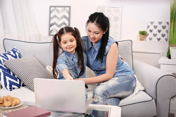 Mother and daughter watching cartoons