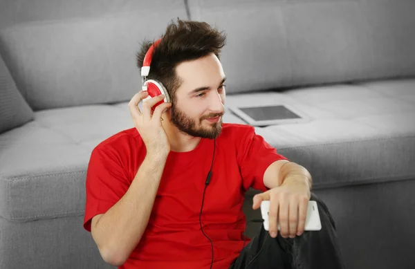 Handsome man listens music with headphones
