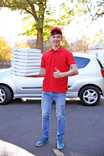 Delivery boy with pizza boxes