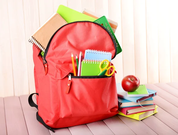 Red backpack full of stationery
