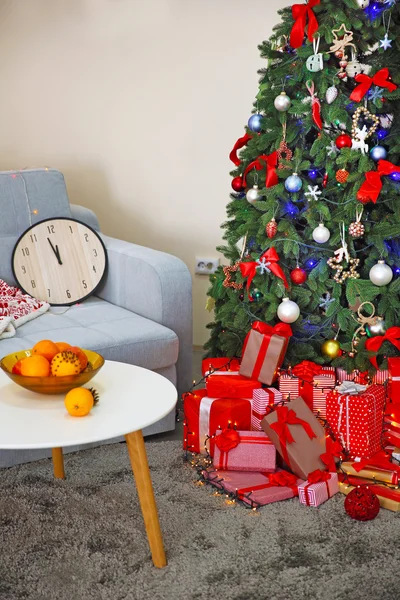 Christmas interior with fir tree, clock and gifts