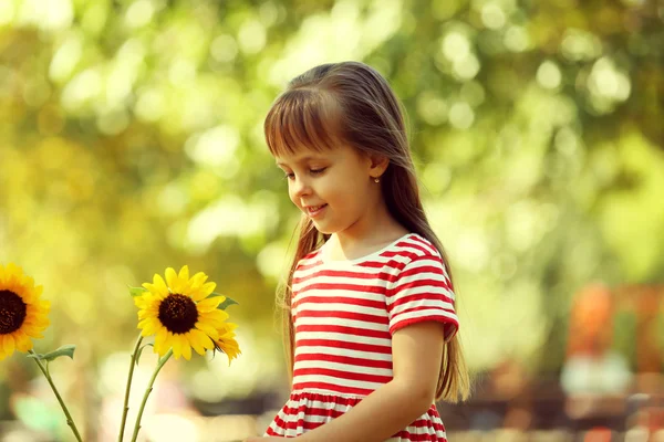 Little girl with sunflowers