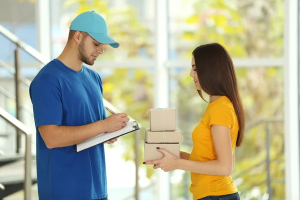 Young woman and delivery man