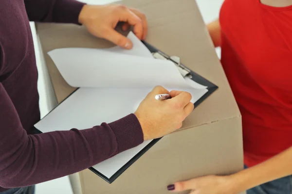 Man signing receipt of delivery package