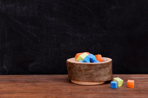 Wooden bowl of coloured chalk