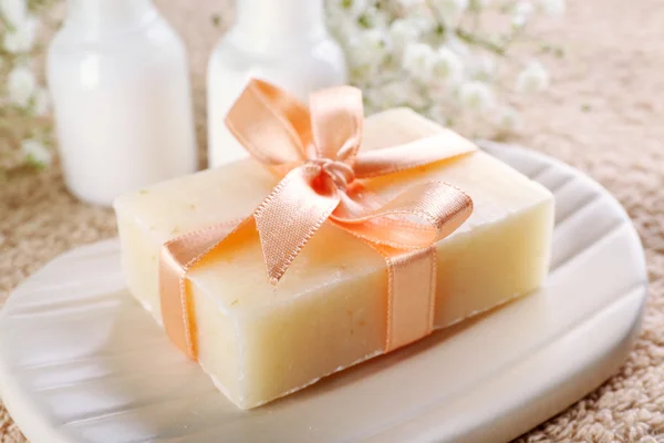 Soap with ribbon on dish