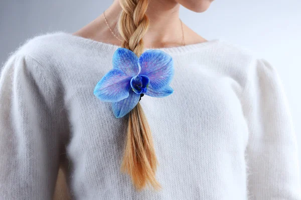 Beautiful blue orchid in woman hair
