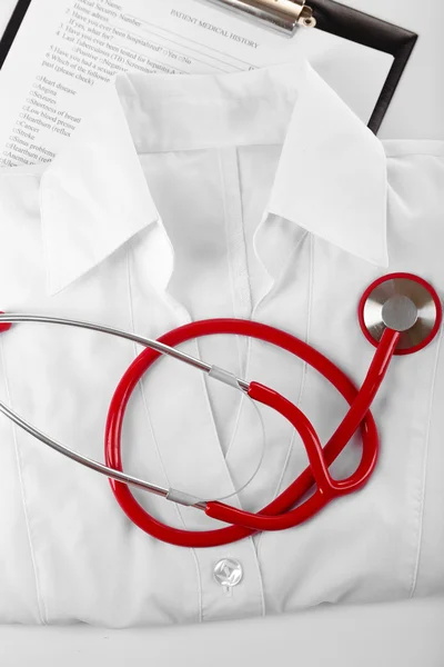Red stethoscope, medical record and uniform