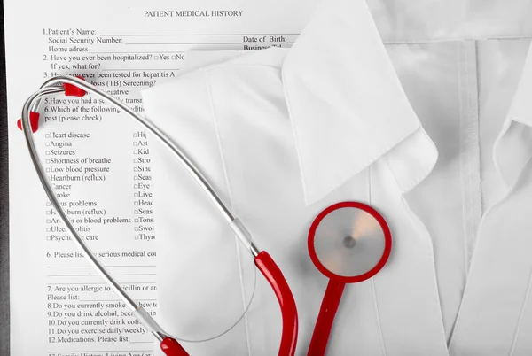 Red stethoscope, medical record and uniform