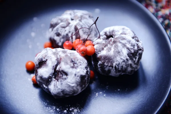 Chocolate balls with ash berry on plate closeup