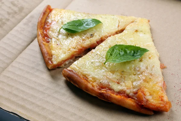 Tasty slices of pizza with basil