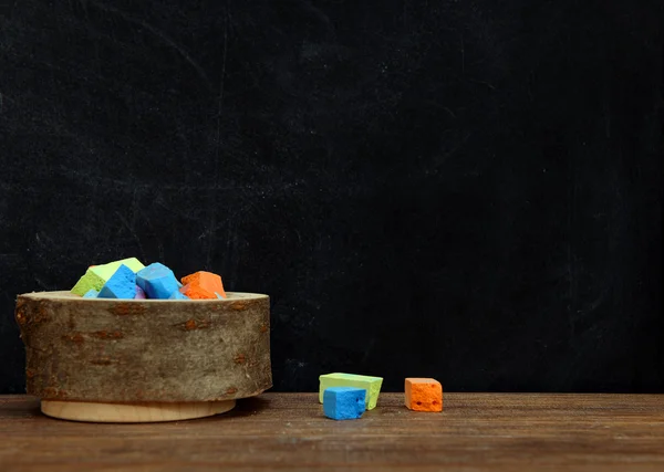 Wooden bowl of colored chalk