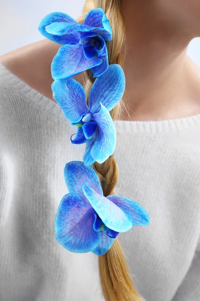 Blue orchid in woman hair