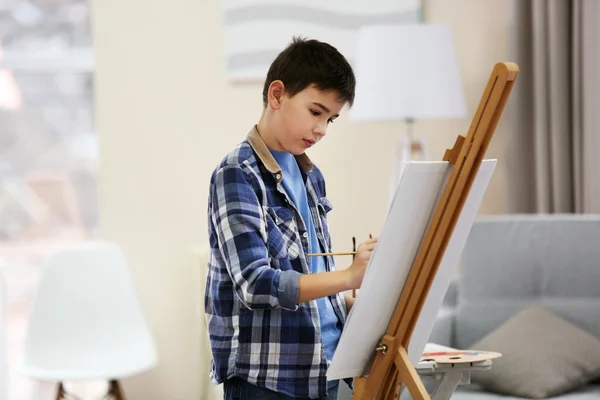 Boy drawing on easel