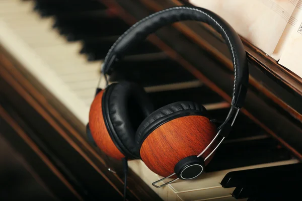 Brown headphones on piano keyboard