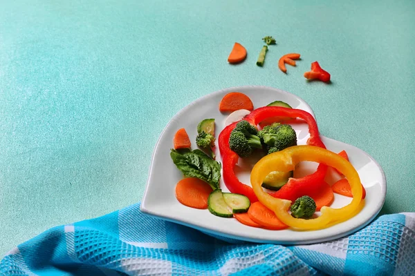 Vegetables on a plate in the form of heart