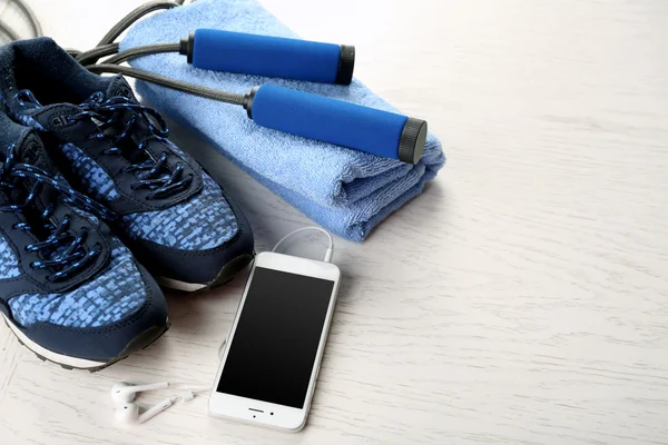 Sport shoes, towel and smart phone