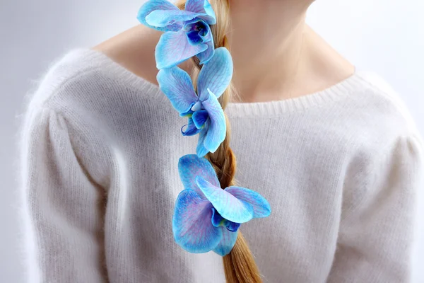 Beautiful blue orchids in woman hair