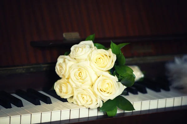 Wedding bouquet on piano background