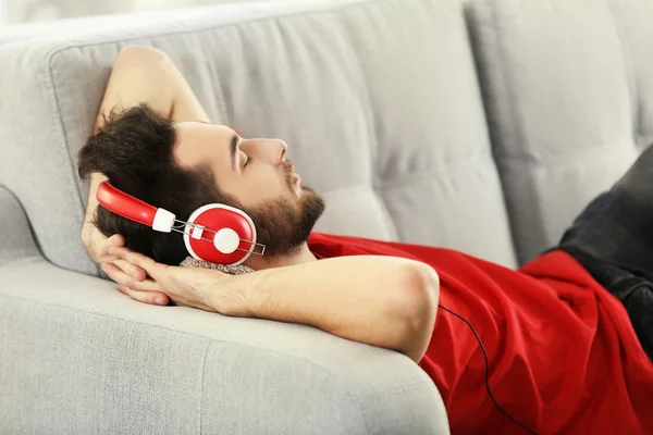 Young man listens music with headphones