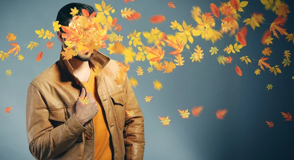 Man and falling autumn leaves