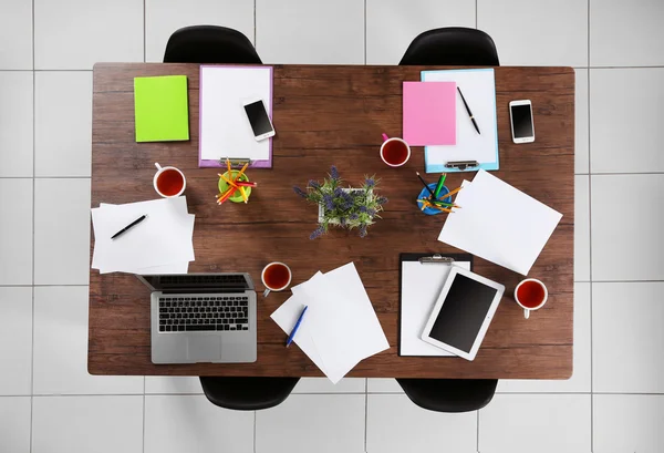 Table with tablet, laptop, papers