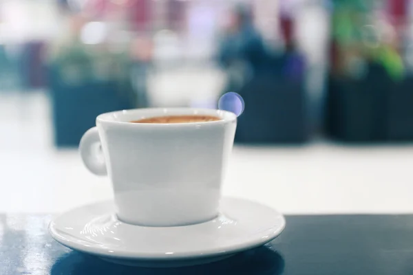 Cup of coffee on the table in the cafe, close up