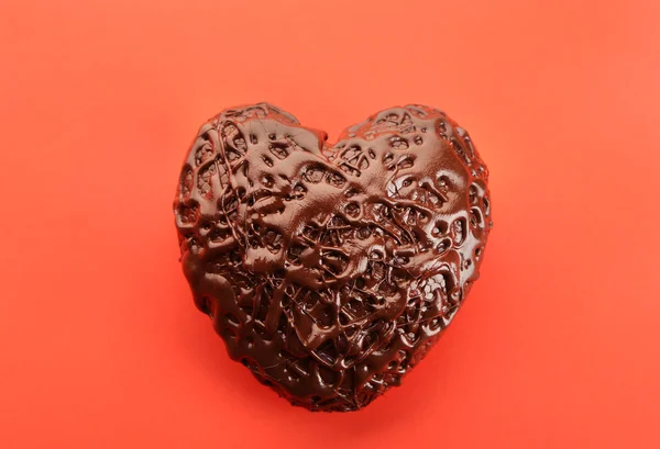 Chocolate heart on a red background