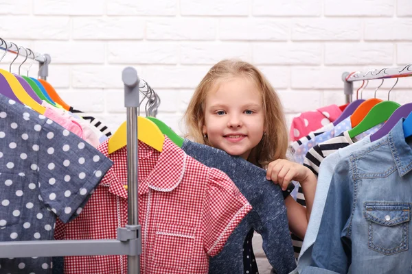 Little girl trying on clothes
