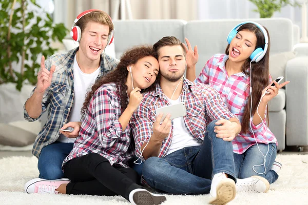 Two teenager couples listening to music